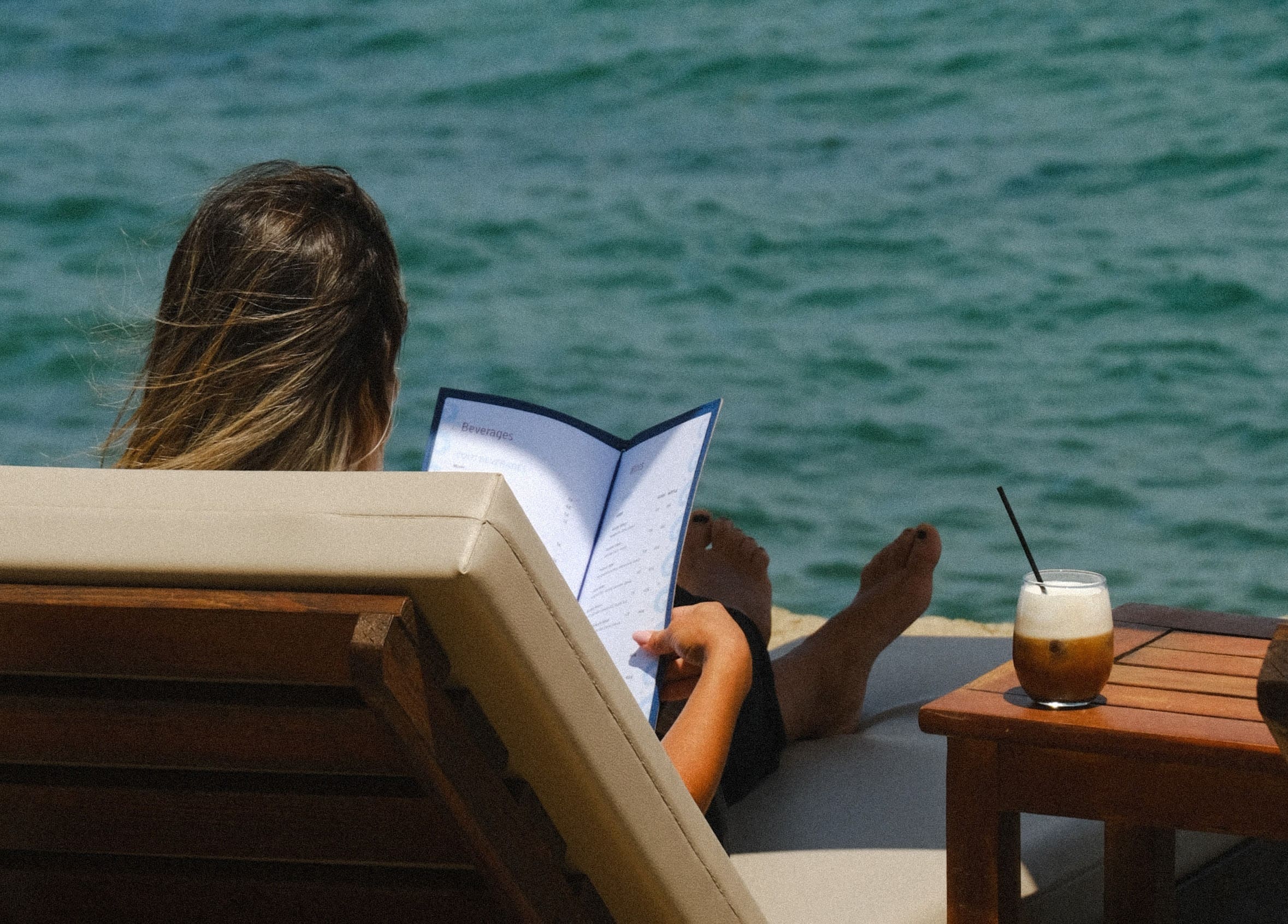 girl sitting on a sunbed at emerald beach bar